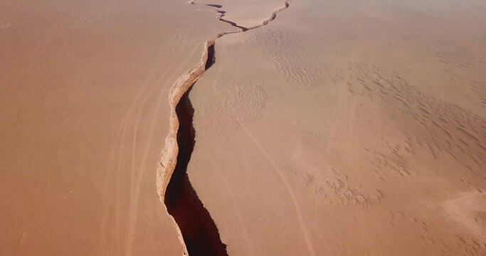 sky line in horizon desert scenic wonderful landscape the geological twin fault on Earth snake tongue  shape canyon deep dark valley crack ground in iran lut natural off road adventure Arabian culture 
