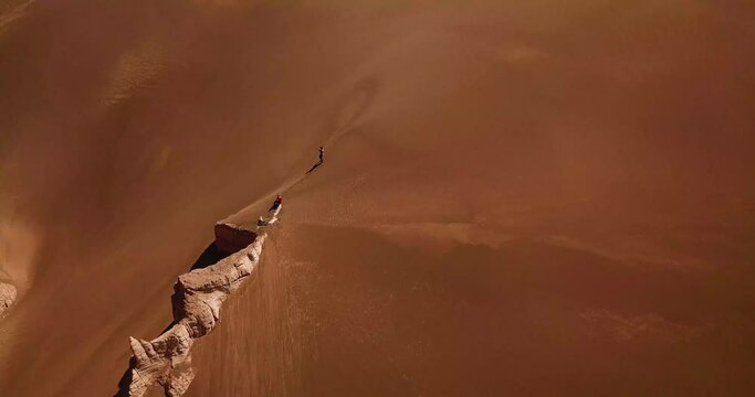 Golden sand dune in the middle of hot dry desert in middle east steep smooth rock clay cliff mountain surrounded by moving particle in Iran geopark nature natural adventure scenic wonderful landscape