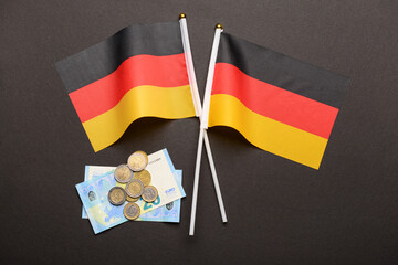 Flags of Germany and money on black background