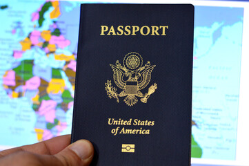 United States of American passport, passports are issued to the American citizens and nationals, Travel, tourism concept, American visa and traveling to other countries, on blurred world map