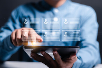Screening employee information and job applicants. Businessman use tablet to checking resume for...