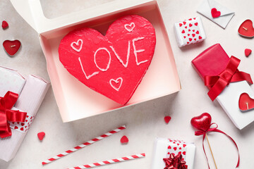 Heart-shaped bento cake with gift boxes on white background. Valentine's Day celebration
