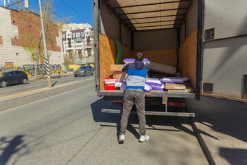 Russia Samara April 15, 2023: young men delivering goods around the city in a truck.