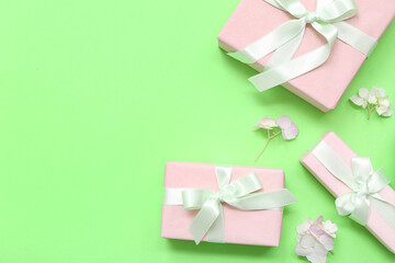 Gift boxes and beautiful hydrangea flowers on green background. International Women's Day
