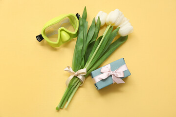 Snorkeling mask, gift box and tulip flowers on color background. International Women's Day