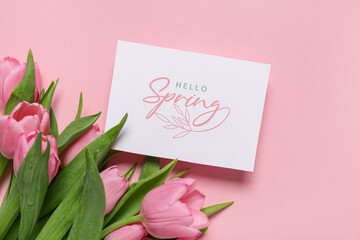 Fototapeta premium Greeting card with text HELLO SPRING and beautiful tulips on pink background