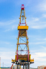 oil and gas drilling rig on a summer sunny day against a blue sky