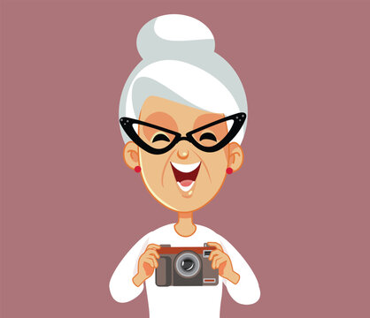 Elderly Woman Holding a Retro Camera Vector Cartoon Character. Senior lady feeling nostalgic holding an analogue photo-camera
