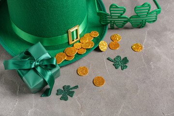 Gift box with leprechaun hat, plastic eyeglasses and decor for St. Patrick's Day celebration on...