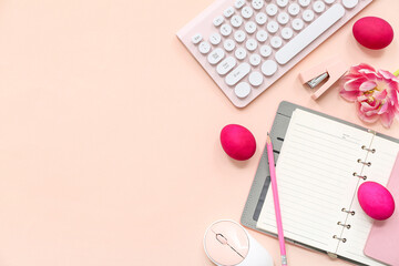 Easter eggs, notebook, flowers, computer keyboard and mouse on pink background