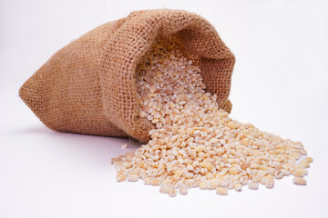 Dry pearl barley in the bag concept background