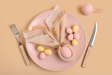 Beautiful table setting with Easter eggs on yellow background