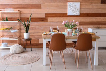 Interior of festive decorated dining room with Easter table setting and chairs