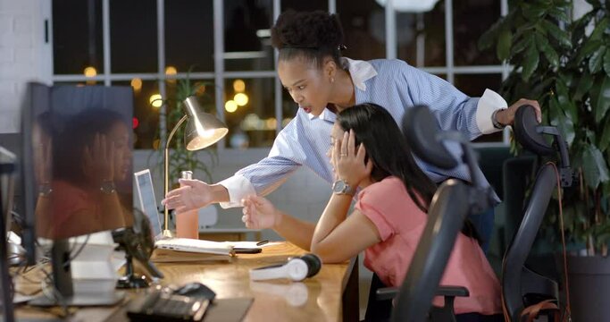 Young African American businesswoman assists biracial woman in office