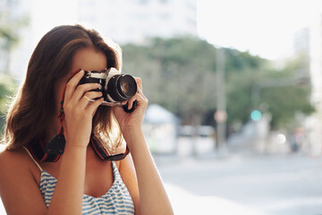 Woman, photography and city street with camera for photo, memory or capturing outdoor moment. Female person, tourist or photographer taking picture with lens for sightseeing or travel in urban town