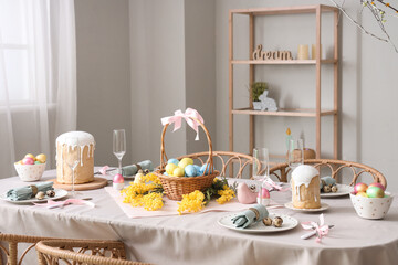 Beautiful table setting for Easter cakes and eggs in dining room