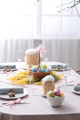 Beautiful table setting for Easter cakes and eggs in dining room