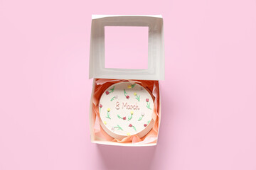 Box with sweet bento cake on pink background. International Women's Day