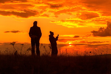 elderly tourists on the Karamuruntau ridge admiring the beautiful sunset on an autumn evening