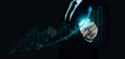 Businessman writes arrows and draws graphs showing the company's business growth.