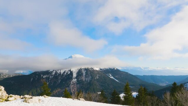 Track in on misty mountain with snow and large cloud in front of the summit, Chamrousse