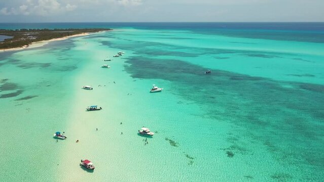 natural pool in the middle of the occean with boats drone shoot