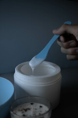 hand holding a spoon of massause lotion