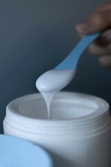 hand holding a spoon of massause lotion