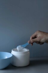 hand holding a spoon of massause lotion