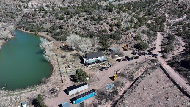 Aerial mountain valley rural farm house river pond Utah. Motoqua is an old historic settlement and a past Vegas gangster retreat. Ghost town. Historic pioneers. Rural community farming agriculture.