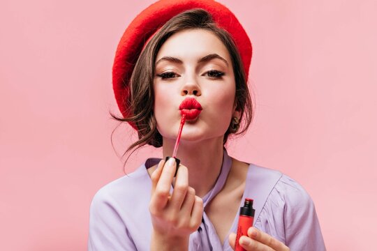 Portrait Young Girl Red Beret Painting Her Lips With Bright Lipstick Pink Background