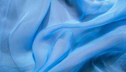 Blue abstract background, the fabric lies in soft waves. chiffon, translucent material. view from above