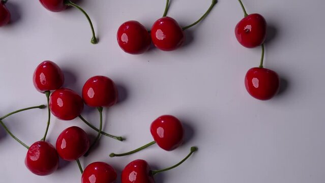 dropping and picking up cherries on a white table