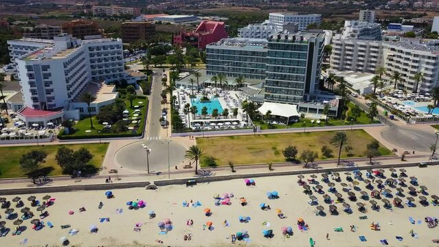 Drone panning from the left going to the right side of the frame showing the whole stretch of Cala Mayor beachfront at Palma de Mallorca, located in the Mediterranean Sea.