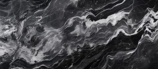 A close-up view of a black and white veined natural marble pattern with a textured surface, set against a black background.