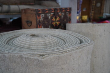 A large roll of felt. Fabric for the yurt, the traditional dwelling of the nomads.