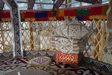A chest with blankets and a pillow in the traditional Kazakh style, with a national ornament.