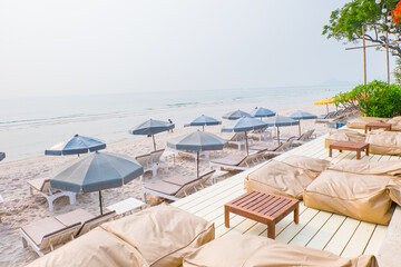 Rows of sun loungers and umbrellas on sandy beach in Tropical Beach,vacation concept.