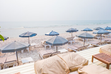 Rows of sun loungers and umbrellas on sandy beach in Tropical Beach,vacation concept.