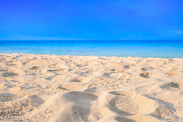 Beach and blue ocean waves for summer vacation concept. Nature of the beach and sea sunny summer The sky is clear. Sandy beach and sparkling sea water