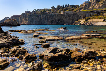 Rocks and cliffs of Capo Taormina cape on Ionian sea shore of Taormina, Giardini Naxos and Villagonia towns in Messina region of Sicily in Italy - 747806924