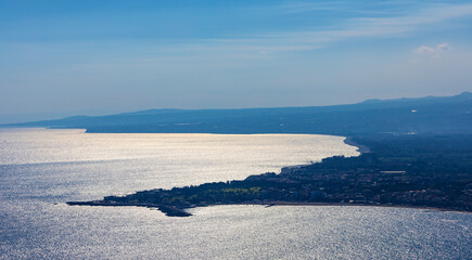 Panoramic view of Taormina shore at Ionian sea with Giardini Naxos and Villagonia towns in Messina region of Sicily in Italy