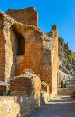 Greek and Roman period Teatro antico Ancient Theatre with stage and arches colonnade ruins in Taormina at Ioanian sea shore of Sicily in Italy - 747807116