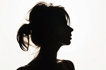 Pretty young woman draped in shadows, her silhouette casting an aura of allure and mystery. photo on white isolated background