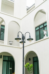 Modern office building white arch wall with street lantern or Streetlights,architecture...