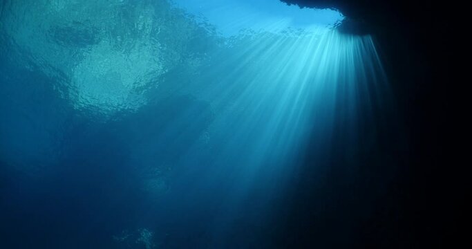 sun rays sun beams and sun shine underwater in cave beautiful light scenery in ocean scuba divers to see