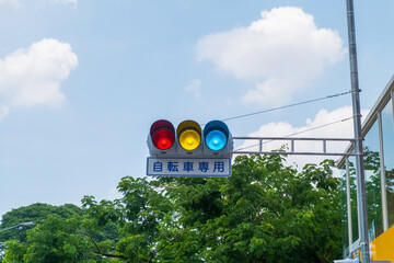 Japanese traffic lights and sign above scramble crossing in front of Tokyo station ,Japanese under the traffic light means "push button type.