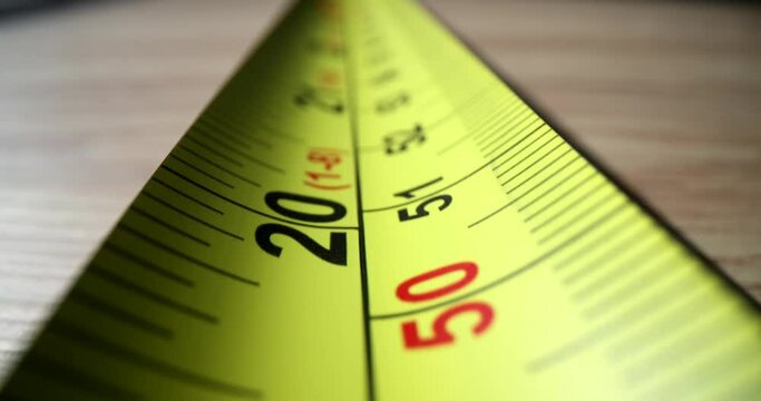 Yellow centimeter tape measure for measuring distance during construction closeup 4k movie. Construction tools concept
