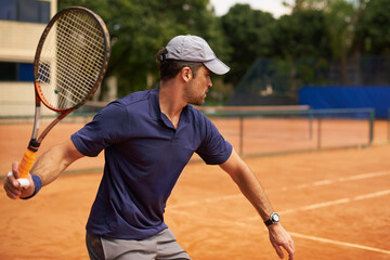 Tennis, sport and man training in game, competition or exercise for fitness on court. Athlete, workout and play on pitch outdoor in summer with action, challenge and person in contest at club