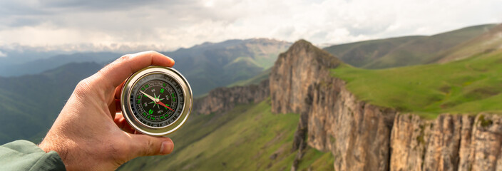 On the ground compass with mountain view